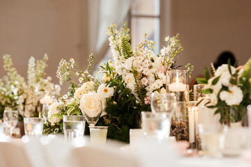 White wedding reception decor with elegant candles