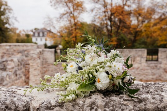 whimsical fall wedding bouquet outdoors on a stone