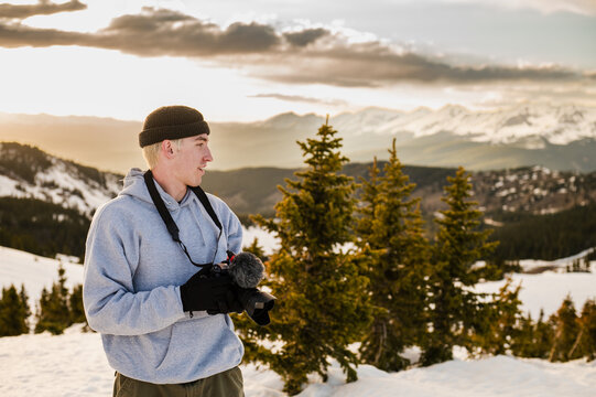 Man with camera overlooking mountain view