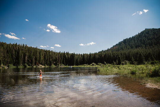 Child playing in lake at Yellowstone National Park during summer