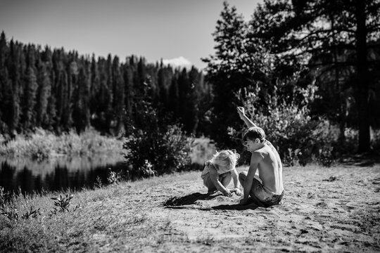 Kids playing in sand on lake shore at Yellowstone National Park