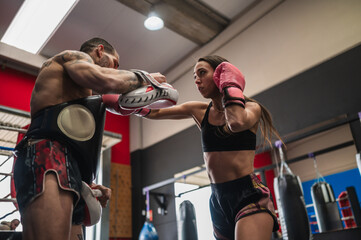 Strong female doing forceful physical attack with trainer