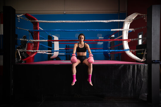 Confident female boxer in sportswear at fitness center