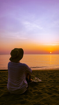 Silhouette of people on the beach under the sunset. Portrait. Romblon, Philippines