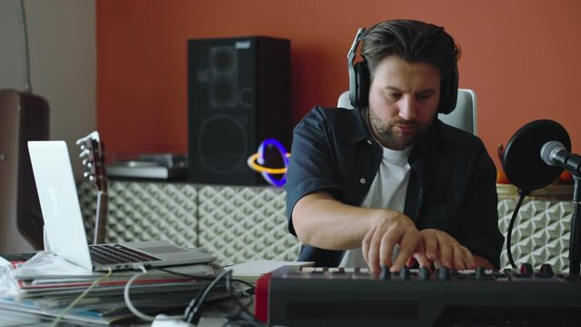 Young Man Practicing His Live DJ Set to create Music at Home, musician live, music Streaming Podcast.
The boy dreams of becoming a Famous Professional Artist.