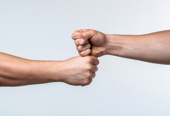 Fist bump. Clash of two fists, vs. Gesture of giving respect or approval. Friends greeting....
