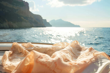 Close focus on a bikini drying on a yacht's bow with the glittering sea and cliffs in background