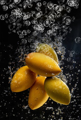 Yellow ripe mangoes falling into deep water, AI generated
