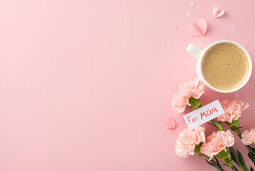 Fashionable Mother's Day theme: top view of a coffee cup, fresh carnations, sweet message 