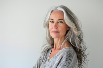Fototapeta premium Closeup portrait of Beautiful mature woman, 50+ years, looking at the camera, white background