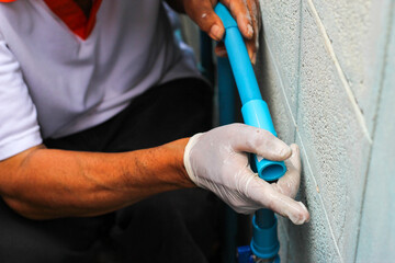 Plumbers are connecting pvc pipe. Plumbing repair service
