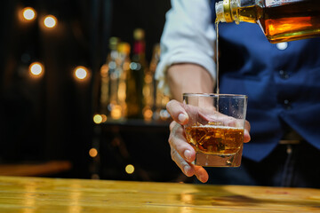 Bartender pouring Whiskey, on  bar