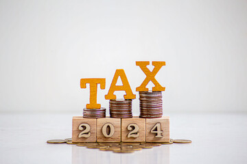 Tax 2024 icon in the wooden cube for income tax return and submit tax for payment tax documents...
