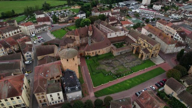 aerial shot over Charlieu Benedictine abbey and Saint Fortunatus priory in Loire department near Roanne on an overcast day, important cluniac site in Auvergne Rhone Alpes region, France