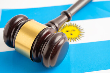 Judge lawyer and US dollar banknotes on Argentina flag, law finance concept.