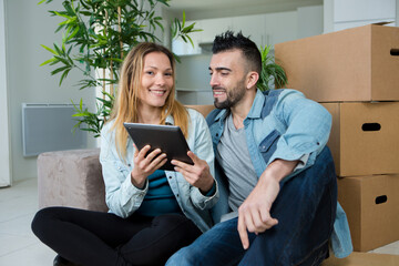 young couple at home using tablet