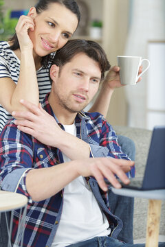 complicit couple looking at a notebook computer