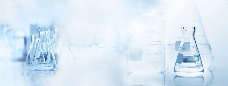 clear beaker and flask glassware in cosmetic science lab background