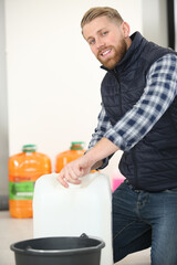 happy male worker fills a container