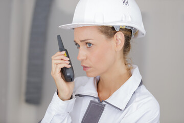 troubled female builder using walkie talkie - 769486005