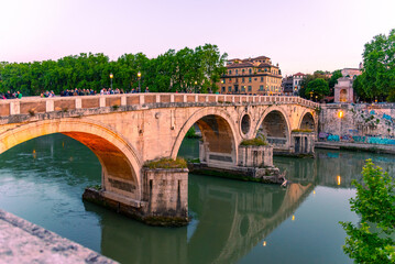 The sun casts a warm glow on the Ponte Sisto bridge, enhancing the historic charm of this ancient...