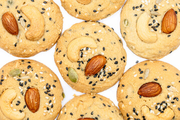 Close Up Healthy Whole Grain Cookies with different seeds, cashew nuts, almond, black sesame, pumpkin seed on white background
