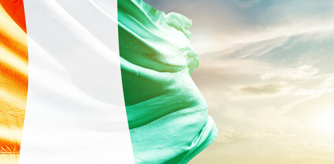Ivory Coast national flag waving in the sky.