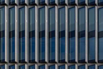 Detail of the facade of modern office building with high windows.