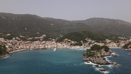 Naklejka na ściany i meble aerial view wild sea waves crushing on rocks in parga town epirus greece
