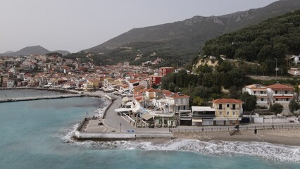Fototapeta na wymiar aerial view wild sea waves crushing on rocks in parga town epirus greece