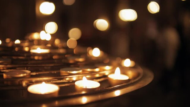 Close up of group of illuminated candles at Notre-Dame cathedral in Paris