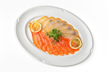 Slices of delicatessen salmon and buttery salted fish on a white plate. Banquet festive dishes. Gourmet restaurant menu. White background.