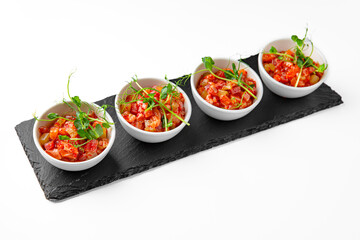 Salmon buffet appetizer, tartare on a white plate. Banquet festive dishes. Gourmet restaurant menu. White background.