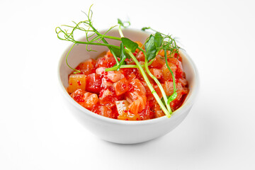 Salmon buffet appetizer, tartare on a white plate. Banquet festive dishes. Gourmet restaurant menu. White background.