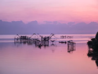 Foto op Canvas Beautiful landscape morning sky sunrise, Fishing using giant nets Thale Noi Wetlands at Baan Pak Pra is a famous landmark of Phatthalung, Thailand. © chirawan_nt