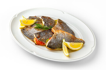 Dorado fish fillet baked with vegetables on a white plate. Banquet festive dishes. Gourmet restaurant menu. White background.
