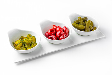 Pickle appetizer mix on a white plate. Banquet festive dishes. Gourmet restaurant menu. White background.