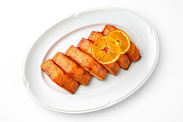 Salmon fillet cooked with vegetables on a white plate. Banquet festive dishes. Gourmet restaurant menu. White background.
