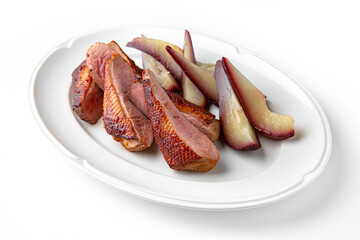 Duck fillet baked with pear in wine on a white plate. Banquet festive dishes. Gourmet restaurant menu. White background.