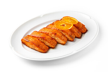 Salmon fillet cooked with vegetables on a white plate. Banquet festive dishes. Gourmet restaurant menu. White background.