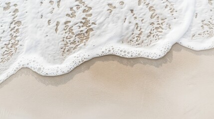 Waves washing onto sandy beach under clear sky, background, wallpaper, top view