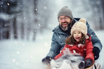Father and daughter enjoying a sled ride in the snow