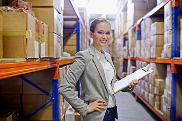 Businesswoman, warehouse and clipboard in portrait for management of logistics, shipping or packaging process. Girl, factory and products in storage for retail, delivery or distribution to store
