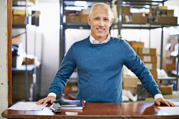 Man, portrait and logistics in warehouse with smile for manufacturing at counter for supply chain,...
