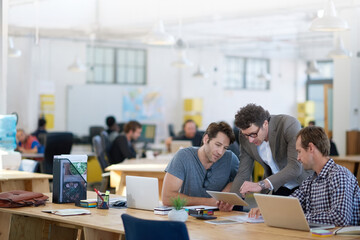 Businessman, office and discussion with teamwork on tablet for planning, research and ideas for...