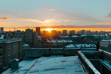 snowy cityscape view from rooftop with person enjoying sunset
