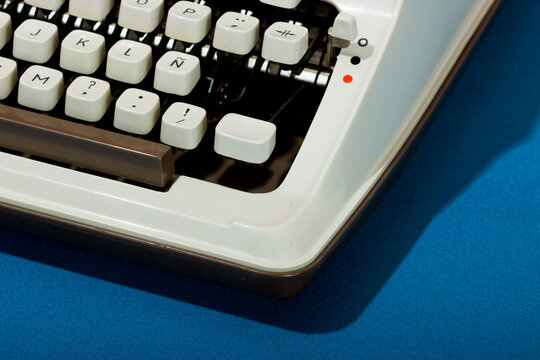 Retro typewriter against blue background