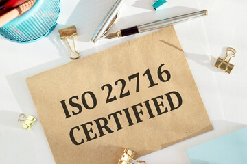ISO 22716 concept, craft envelope on desk with iso 22716 icon.