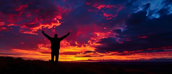 In the sunset concept, a silhouette of a man is seen raising his hands in prayer, worship, and praise.