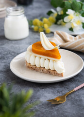 A cream vanilla entremet biscuit in a petal shape, topped with white chocolate and apricot confit...